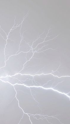 lightning strikes across the sky in an overcast day, with no clouds or lightenings