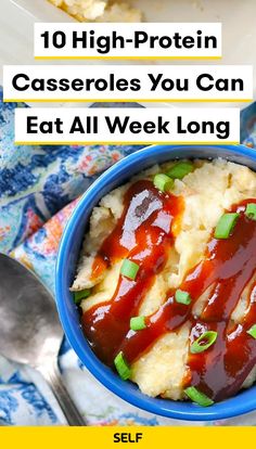 a blue bowl filled with mashed potatoes covered in ketchup