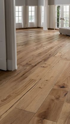 an empty living room with wood floors and white walls