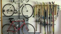 a bicycle is parked next to a rack with skis and snowboards on it