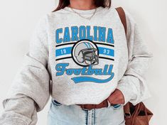 WELCOME TO MY STORE ♥️ This Carolina Football Crewneck, Panthers Sweatshirt, Vintage Carolina Football Crewneck Sweatshirt, Carolina Football T-Shirt. Please check Color and Size Charts before placing the order. You can find them in the listing's photos (Depending on what device you are viewing this listing colors may vary slightly). _UNISEX T-SHIRT * 100% cotton for solid colors * Heather colors are 35% ring-spun cotton, 65% polyester * Sport Grey is 90% cotton, 10% polyester #Care: Machine was Football Super Bowl, Vintage Tennessee, Carolina Football, Sunday Football, Tennessee Football, Football Vintage, Football Sunday, Football Sweatshirt, Football T Shirt