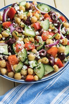 a salad with chickpeas, cucumbers, tomatoes and feta cheese