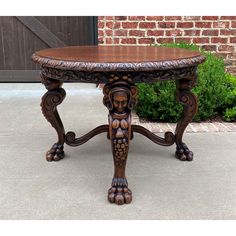 an ornately carved wooden table sitting on the sidewalk in front of a brick building