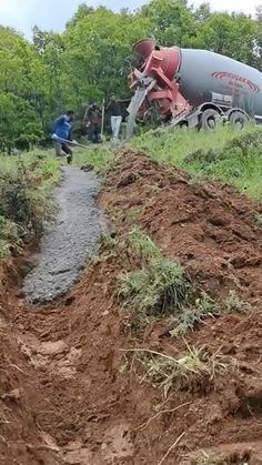 a cement truck parked on top of a dirt hill