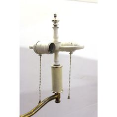 an old fashioned faucet with chains hanging from it's sides and a pipe attached to the side