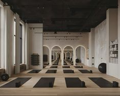 an empty gym with yoga mats and exercise balls