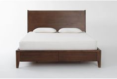 a bed with two white pillows on top of it