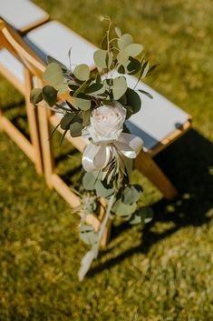 a bouquet of flowers sitting on top of a wooden bench