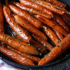 a pan filled with cooked carrots on top of a table