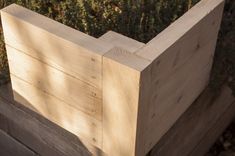 a wooden planter box with plants growing in it