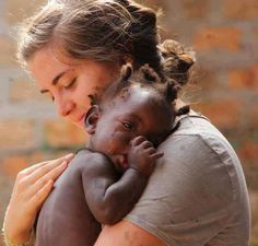 a woman holding a baby in her arms with the caption that reads, office tu bomba todos recuerada que sembras los que coschas