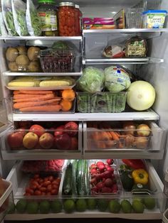 an open refrigerator filled with lots of fresh fruits and vegtables in containers