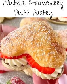 a hand holding a strawberry puff pastry with the words nutella strawberry puff pastry on it