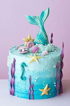 a cake decorated with blue icing and sea creatures