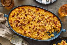 a casserole dish with meat and cheese in it on a table next to other dishes