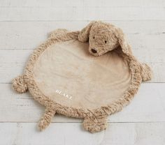 a stuffed animal laying on top of a wooden floor