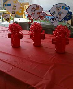 red fire hydrant centerpieces on top of a table covered in red cloth