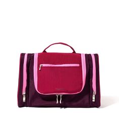 a pink and purple bag with zippers on the front, sitting against a white background