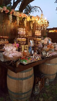 an outdoor dessert table with wine barrels