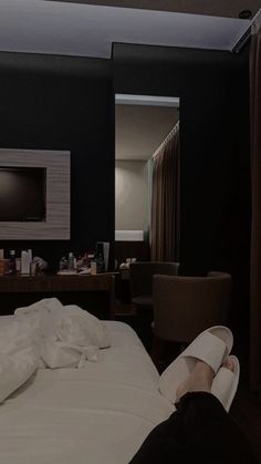 a person laying on a bed in a hotel room