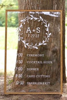 a sign on the side of a tree in front of a forest