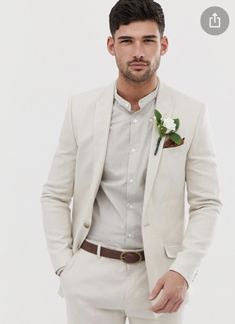 a man in a white suit with a boutonniere