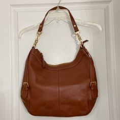 Brown Leather. Gold Hardware. Handle Drop 12''. Outer Zip Pocket. Zipper Closer. Inside Ip And 2 Slide Into Pockets. Size; W 14'' X H 11.5'' X D 3.5''. With Dust Bag. Nwot Ora Delphine Jacqueline Leather Hobo 0523420/365 C&B17 Made With A Full Grain Leather, The Scars, Scratches, Veins And Wrinkles Are Natural Marking Characteristics. Nwot, Overall In Excellent Condition. Cognac Shoulder Bag With Gold-tone Hardware, Cognac Shoulder Bag With Gold-tone Hardware For Errands, Leather Hobo, Full Grain Leather, Gold Hardware, Wrinkles, Brown Leather, Zip Pockets, Dust Bag