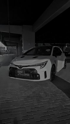 a white car parked in front of a building