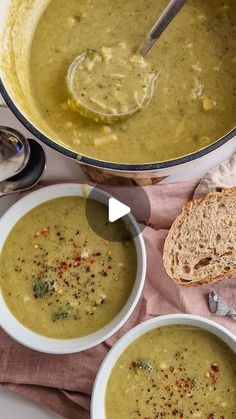 two bowls filled with soup next to bread