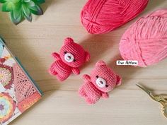 three crocheted teddy bears sitting on top of a table next to yarn and scissors