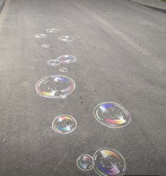 soap bubbles are drawn on the asphalt in front of an empty street