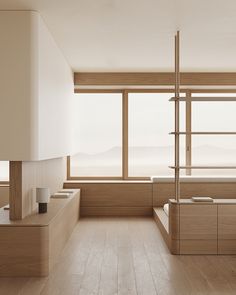 an empty bathroom with wooden floors and large windows