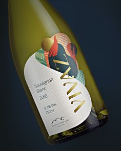 a close up of a bottle of wine on a black background with gold foiling