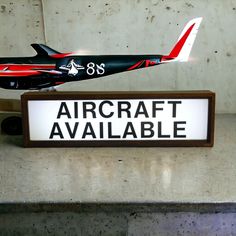 a model airplane sitting on top of a sign