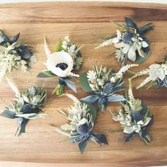 flowers are arranged on top of a cutting board