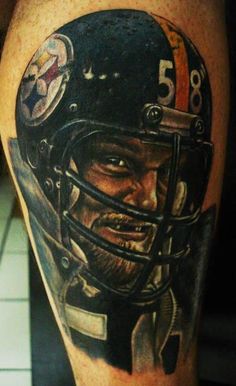 a man with a football helmet tattoo on his leg is shown in front of the camera