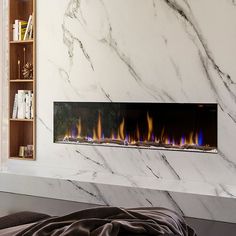 a modern fireplace with white marble and blue flames