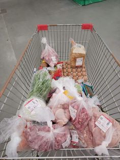 a shopping cart filled with meat and eggs