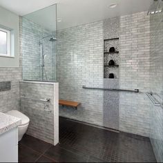 a bathroom with a sink, shower and toilet