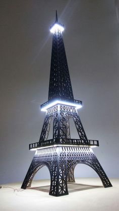 the eiffel tower is lit up at night with its lights on and around it