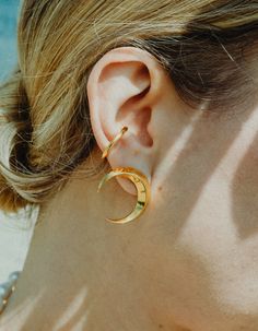 Symmetrical moon-shaped earrings made of sterling silver or sterling silver plated with 24 ct gold. Motif diameter: 24 mm. Decorative engraving on the reverse.We observe the phases of the Moon on Earth trying to solve the mystery of lunar attraction, but one side of this peculiar celestial body is always hidden in the shade of the Sun. Moon Phases Earrings, Celestial Gold-plated Single Earring, Celestial Gold Plated Single Earring, Celestial Single Gold Plated Earring, Celestial Gold-plated Earrings, Celestial Gold-plated Pierced Earrings, Celestial Gold Plated Pierced Earrings, Gold Plated Celestial Pierced Earrings, Elegant Moon-shaped Gold Plated Earrings