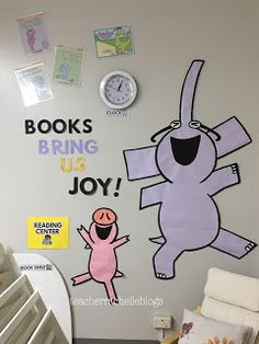 a child's room decorated with books, toys, and posters on the wall