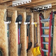 several different tools are hanging on the wall