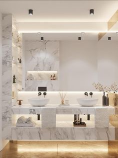 a large bathroom with two sinks and marble counter tops on the wall, along with lights