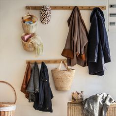 the coat rack is filled with coats and baskets