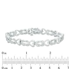 Pump up the fashion volume with this shimmering diamond link bracelet. Crafted in sterling silver, each link features a polished and sparkling diamond-lined loop that creates a square knot - topped with a polished heart outline. Radiant with 1/2 ct. t.w. of diamonds and a brilliant buffed luster, this 7.0-inch bracelet secures with a tongue and groove clasp. Silver Heart Bracelet With Diamond Accents For Anniversary, Infinity Diamond Bracelet For Anniversary, Diamond Infinity Bracelet For Anniversary, Fine Jewelry Silver Diamond Heart Bracelet, Silver Heart Diamond Bracelet, Silver Heart Shaped Diamond Bracelet, Silver Tennis Bracelet For Anniversary On Valentine's Day, Silver Infinity Diamond Bracelet For Anniversary, Silver Heart Shaped Diamond Bracelet With Accents