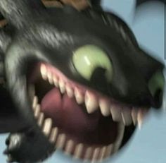 a black dragon with green eyes and sharp teeth