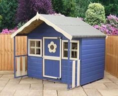 a blue and white shed sitting on top of a patio