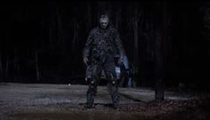 a man standing in the woods at night with his head turned to look like he is walking