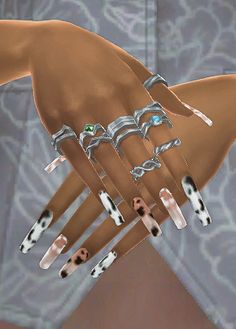 a woman's hand with several different rings on it